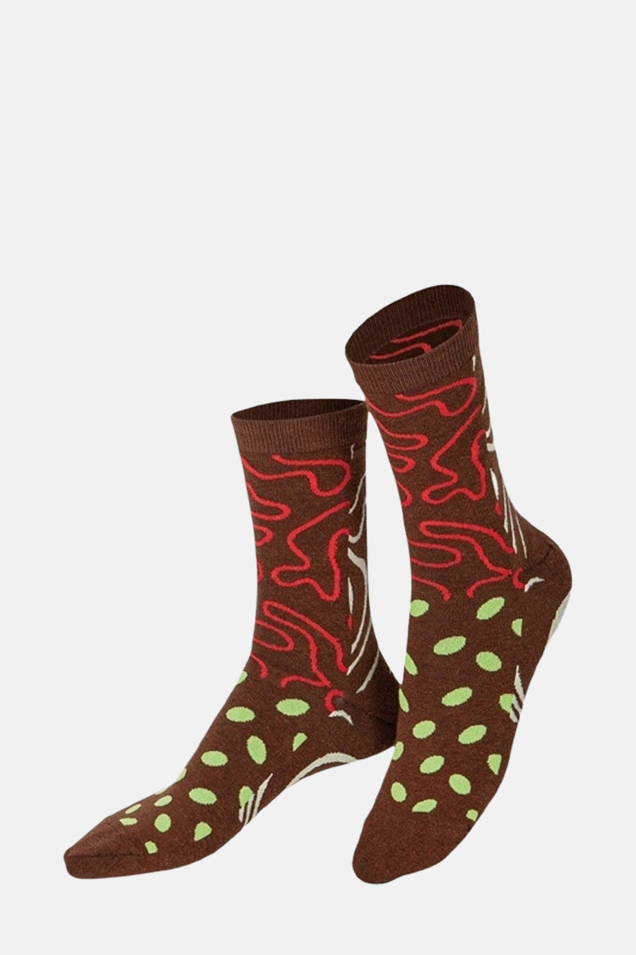 Chaussettes brunes d'EAT MY SOCKS avec des lignes rouges et un motif de points verts.