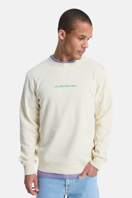 Pull écru Quiksilver, avec un col violet et le logo sur la poitrine.