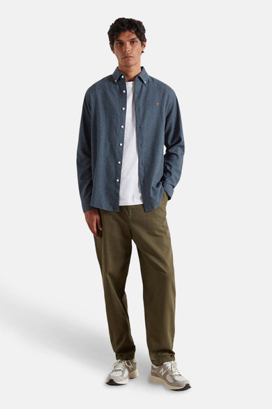 Blau, longsleeve shirt van FARAH, gedragen over een wit T-shirt en met olijfgroene broek en sneakers.