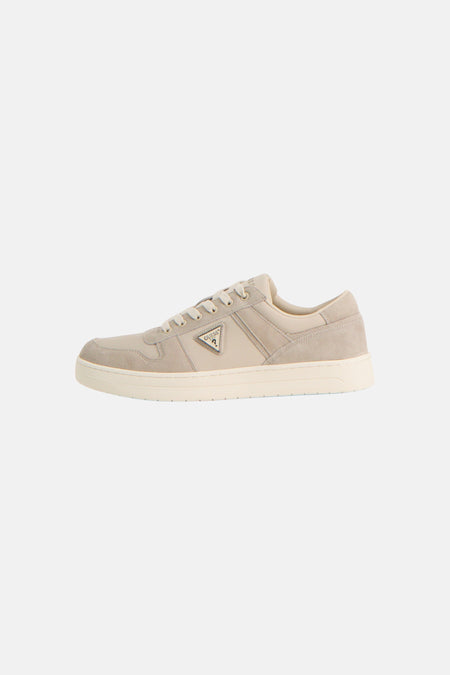 Baskets beiges Guess® avec un logo triangulaire sur le côté et une semelle plate.