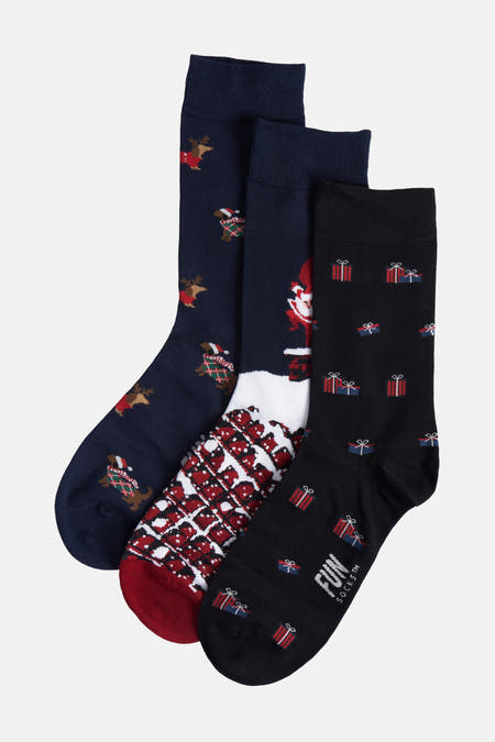 Chaussettes multicolores de FunSocks avec des thèmes de Noël, notamment des rennes et des cadeaux.