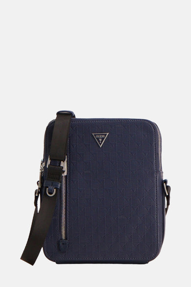 Sac à dos bleu de Guess, avec un motif géométrique subtil et une sangle d'épaule noire.