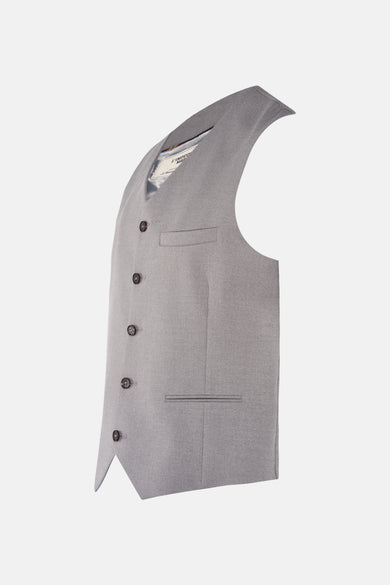 Grijs gilet van Le Fabuleux Marcel de Bruxelles, met knopen en zakken, in een zijdelings perspectief.
