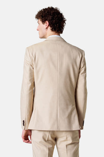 Blazer beige de Le Fabuleux Marcel de Bruxelles, vu de l'arrière, avec des boutons foncés sur les manches.