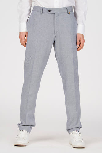 Pantalon de costume bleu de Le Fabuleux Marcel de Bruxelles, vu de dos, avec poches et passants de ceinture, combiné avec une chemise blanche et des baskets.