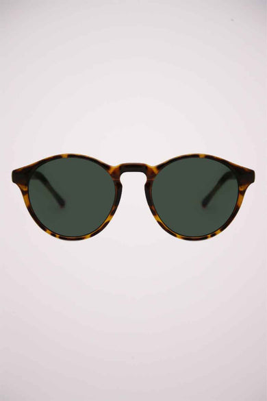 Lunettes de soleil vertes de KOMONO, avec un cadre à motif tortue.