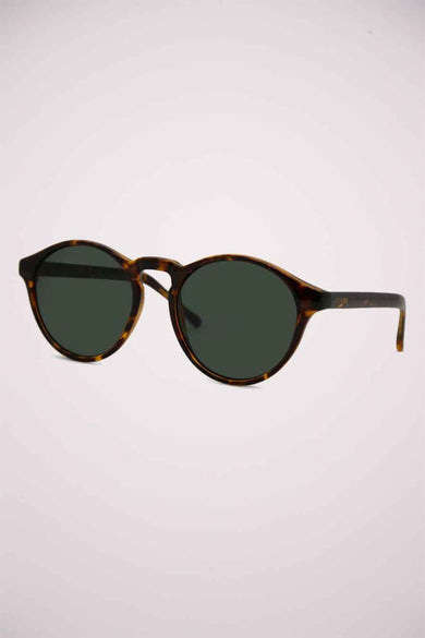 Lunettes de soleil vertes de KOMONO avec un cadre à motif de tortue brune, dans le coin supérieur droit.