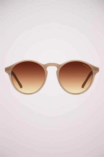 Beige zonnebril van KOMONO, met bruin verloopglas en afgeronde monturen.