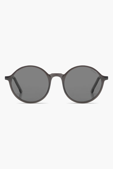 Lunettes de soleil grises de KOMONO avec un cadre élégant et des verres foncés.