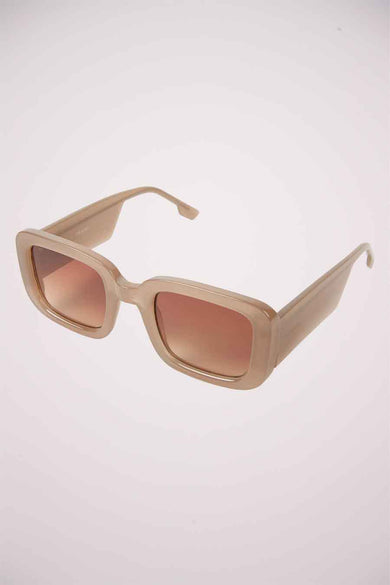 Lunettes de soleil beige de KOMONO avec des montures rectangulaires et des verres teintés marrons.