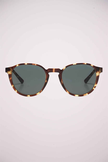 Lunettes de soleil vertes de KOMONO avec un cadre en motif tortue.