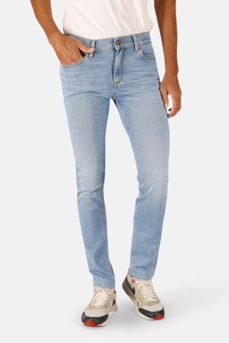 Jeans slim van lichtblauwe denim van Lee Cooper®, gedragen met witte sneakers.