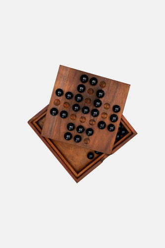 Bruine houten spelbord met zwarte glazen marbles, van SUCK UK, opengeklapt in diagonale hoek, met zichtbare houtstructuur en gatenpatroon