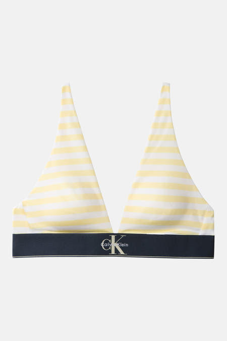 Gestreepte gele beha van Calvin Klein met witte strepen en een donkerblauwe logoband.
