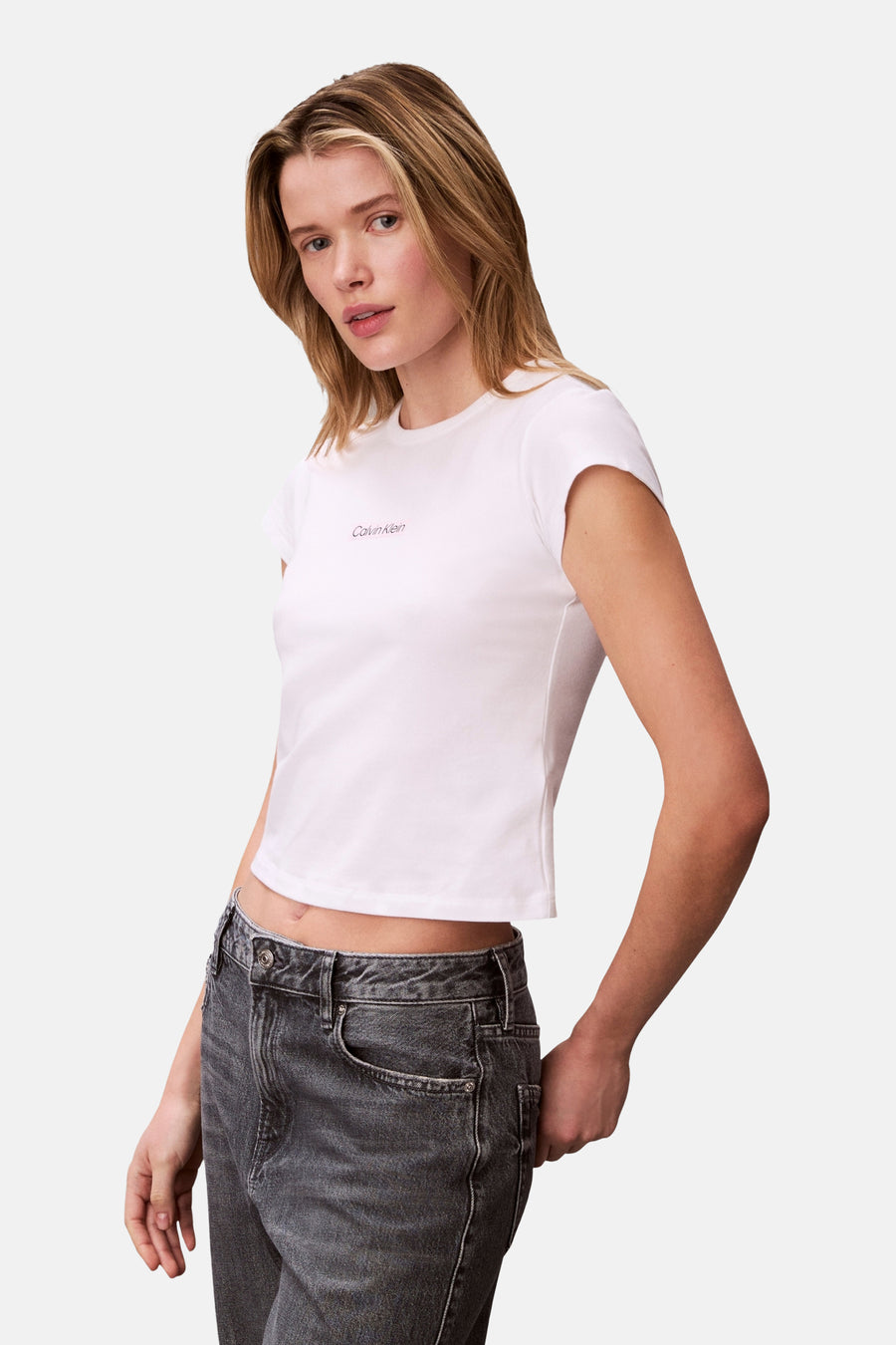 T-shirt blanc à manches courtes Calvin Klein, porté avec un jean gris.