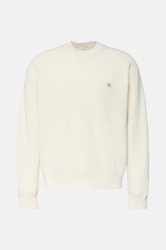 Marinière beige Calvin Klein avec col rond, logo subtil sur la poitrine et structure à carreaux.