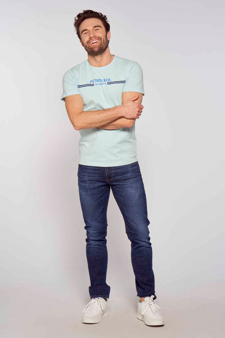 Lichtblauwe korte mouwen T-shirt van Petrol Industries® met logo en strepen, gedragen door model in lifestyle pose