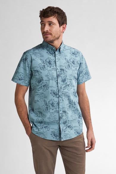 Blauw overhemd met korte mouwen van Petrol Industries®, met bloemenprint en bruine broek.
