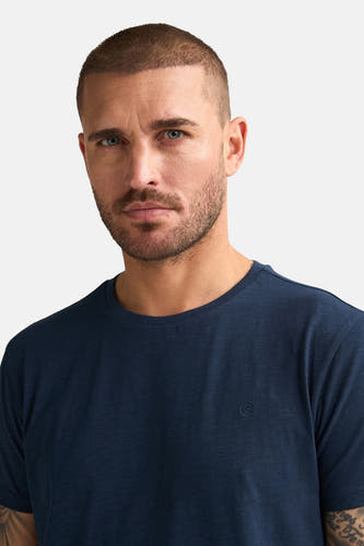 Blauw T-shirt met korte mouwen van Petrol Industries®, effen ontwerp, gedragen door een man.
