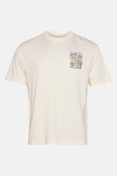 Ecru T-shirt met korte mouwen van Guess met bloemenillustratie en 'Guess Design' tekst.
