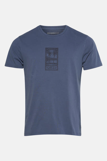 T-shirt bleu à manches courtes de Guess, avec une impression graphique de palmiers.