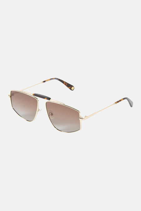Lunettes de soleil couleur or de Le Fabuleux Marcel de Bruxelles avec verres marron dégradés, branches écaille de tortue et pont supérieur noir, vues de biais de face.