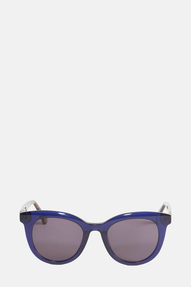 Lunettes de soleil bleues de Le Fabuleux Marcel de Bruxelles, avec un cadre distinctif et des verres foncés.
