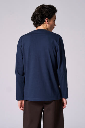 T-shirt bleu à manches longues de Le Fabuleux Marcel de Bruxelles, vu par derrière, associé à un pantalon marron.