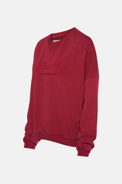 Gilet rouge de Le Fabuleux Marcel de Bruxelles, avec du texte brodé à l'avant.