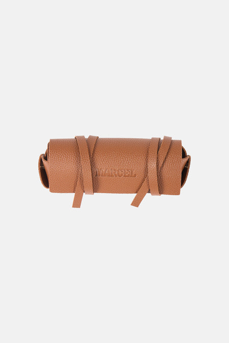 Étui à lunettes en cuir marron de Le Fabuleux Marcel de Bruxelles, avec des sangles pour serrer l'étui.