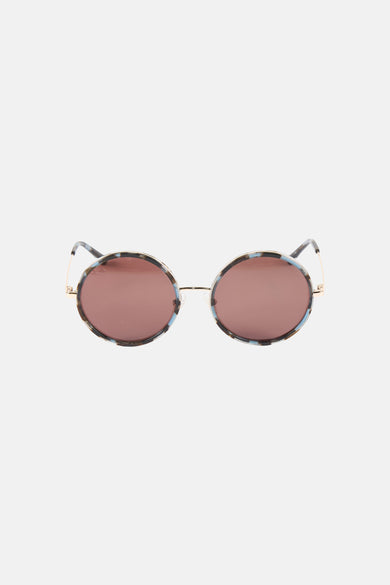 Lunettes de soleil bleues de Le Fabuleux Marcel de Bruxelles avec verres ronds et une monture mouchetée.