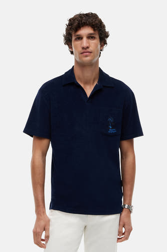 Polo en éponge bleu marine de Tommy Hilfiger avec col ouvert et logo palmier brodé sur la poche poitrine.