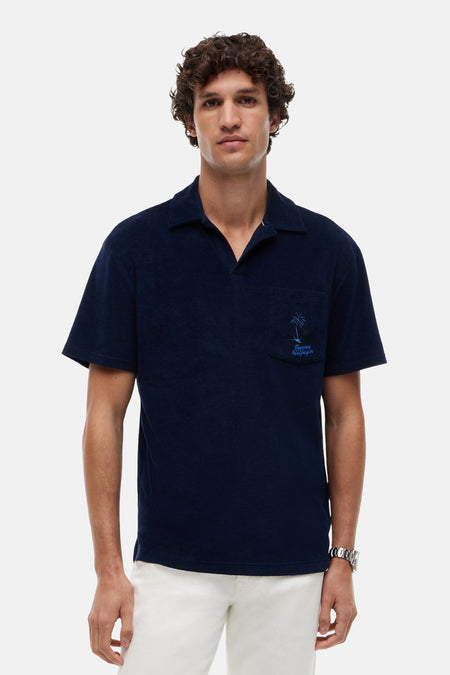 Blauwe polo van TOMMY HILFIGER van badstof met open kraag en geborduurde palmboom.