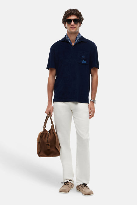 Blauwe polo van terry van TOMMY HILFIGER met borstzak en geborduurde palmboom.
