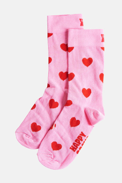 Roze sokken van Happy Socks, met een rode hartjesprint en 'Happy' tekst op de voet.
