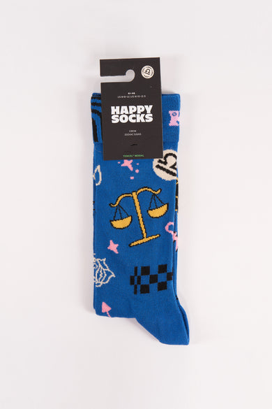 Chaussettes bleues de Happy Socks avec des motifs d'animal, une balance et divers symboles astrologiques.