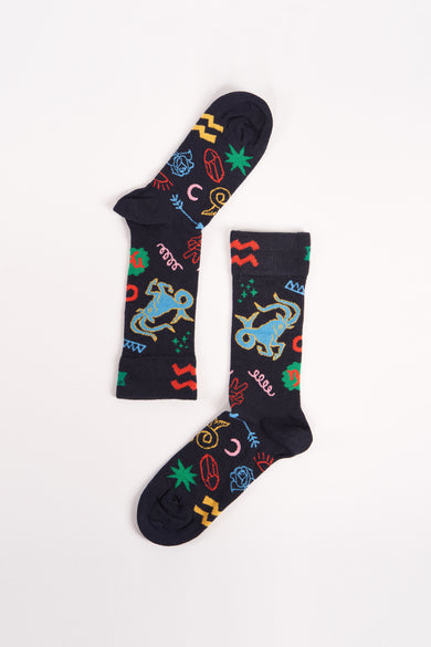 Chaussettes bleues de Happy Socks® avec des symboles et des motifs colorés.
