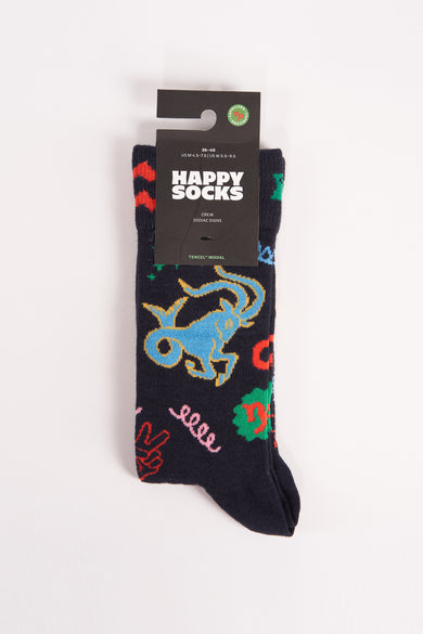 Chaussettes bleues de Happy Socks avec des images d'étoiles colorées, y compris le Capricorne et d'autres symboles.