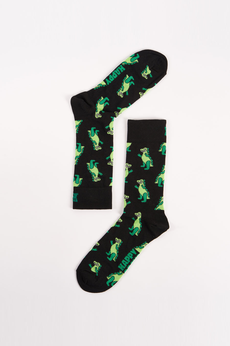 Zwarte sokken van Happy Socks met een groen dinosauruspatroon en het woord "HAPPY".
