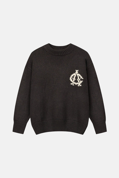 Bruine trui met ronde hals van ANOTHER COTTON LAB, met gebreide decoratieve details op de borst.
