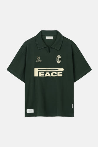Groene polo met korte mouwen van ANOTHER COTTON LAB, met logo's en een 'PEACE'-opdruk.
