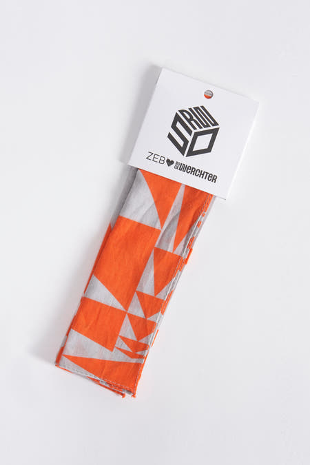 Oranje zomersjaal van Rock Werchter met geometrisch driehoekspatroon, in verpakking.