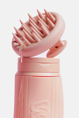 Produit de soin rose de WONDR CARE, avec des brosses et une goutte de liquide.