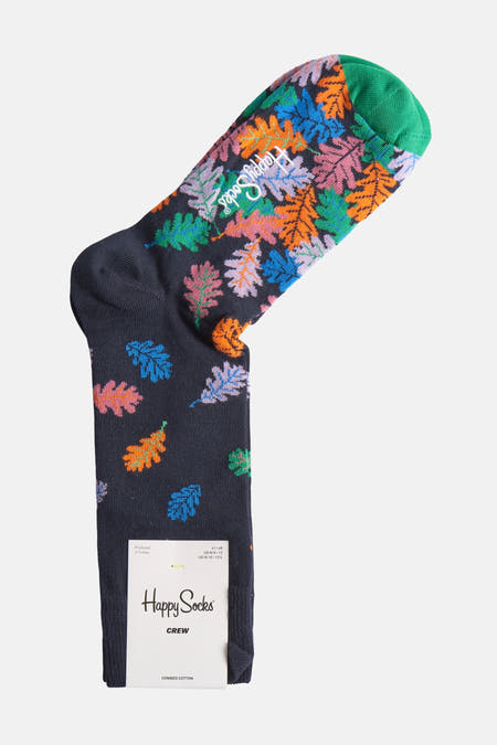 Chaussettes bleues de Happy Socks avec un motif de feuille coloré et des orteils verts.