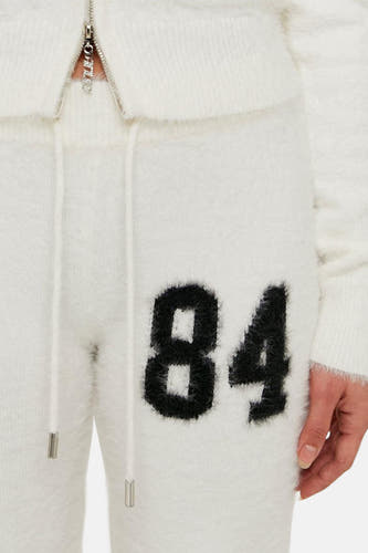 Short de jogging T TALLYALL WEL, avec uneordord et une application noire avec le numéro 84.