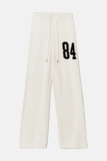Witte joggingbroek van TALLY WEIJL, met een grote, zwarte "84" op het rechterbeen en een trekkoord.