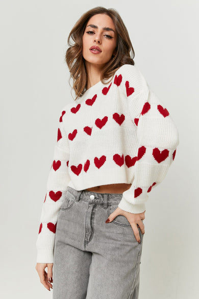 T-shirt blanc avec motif de cœur de TALLY WEIJL, associé à des jeans gris, posé debout.