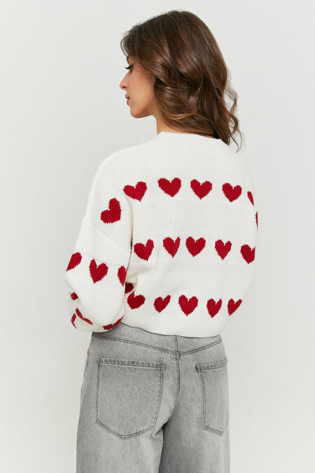 Pull-over blanc de TALLY WEIJL, avec un motif de cœurs rouges et des manches longues, associé à des jeans gris, vu de dos.