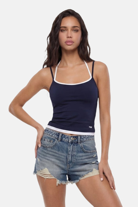 Marineblauwe top met spaghettibandjes van TALLY WEIJL, met witte bies en '7W' logo, gedragen met denim shorts.