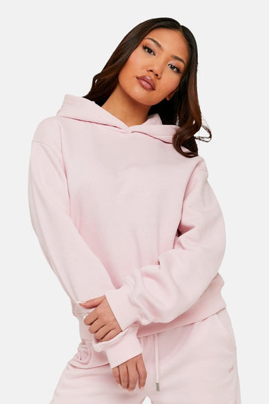 Sweat à capuche rose de TALLY WEIJL, porté par un mannequin aux cheveux détachés.